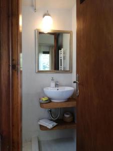 a bathroom with a white sink and a mirror at Deluxe house in Tsangarada in Tsagarada +49 photos