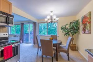 a kitchen and dining room with a table and chairs at the Juliet, Best Area, 2 Bedrooms, WD, Jacuzzi Bath, New Carpet, 825sf in Tacoma +28 photos