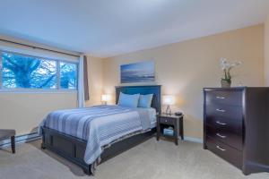 a bedroom with a bed and a dresser and a window at the Juliet, Best Area, 2 Bedrooms, WD, Jacuzzi Bath, New Carpet, 825sf in Tacoma