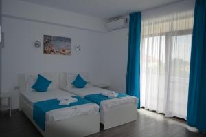 Postel nebo postele na pokoji v ubytování Techirghiol Blue