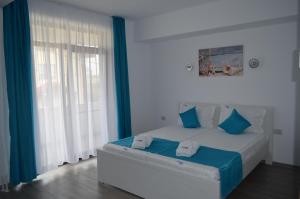 Postel nebo postele na pokoji v ubytování Techirghiol Blue