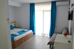 Postel nebo postele na pokoji v ubytování Techirghiol Blue