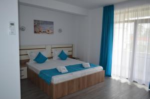 Postel nebo postele na pokoji v ubytování Techirghiol Blue