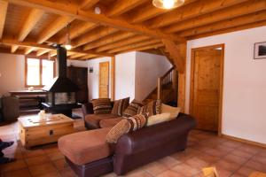 a living room with two couches and a fireplace at Chalet Gyronde in Vallouise