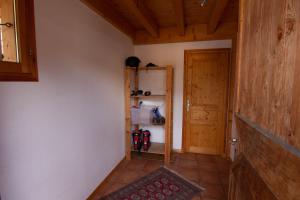 a hallway with a refrigerator and a door in a room at Chalet Gyronde in Vallouise