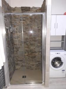 a shower in a bathroom with a washing machine at Casa Caterina in La Spezia