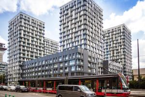 a bus stop in front of two tall buildings at Prague apartment in residential tower · parking in Prague