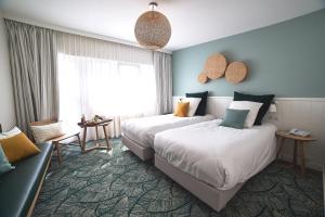 Postel nebo postele na pokoji v ubytování Le Manoir Hôtel