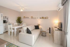 a living room with a white couch and a table at Bayview Apartment in Selce