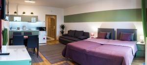 a bedroom with a large bed and a kitchen at Prague apartment in residential tower · parking in Prague