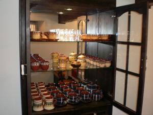 a display cabinet filled with lots of jars of food at Къща за гости Старият Град Златоград in Zlatograd