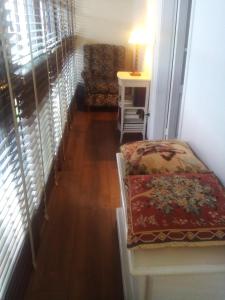 a hallway with a couch and a table and a window at Casa de Aldea la Galeria habitación en casa particular in poo de Llanes