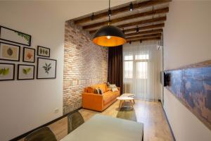 a living room with a couch and a table at RIS Dalma Collection Yerevan in Yerevan
