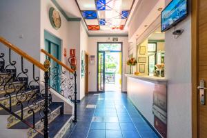 a hallway of a home with a staircase and a glass ceiling at Elcano in Málaga