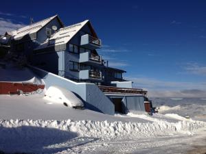 a building on top of a snow covered slope at Ski in-out Apartment in El Colorado in El Colorado