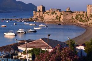 a group of boats in a body of water with a castle at A & V Luxury apartment - Kalamata in Kalamata
