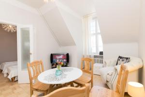 a living room with a table and chairs and a couch at Suurkarja Apartment in Tallinn