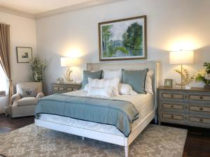 a bedroom with a bed and a couch and a chair at The William Boerne in Boerne