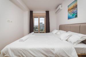 Postel nebo postele na pokoji v ubytování Blue Marlin Apartments
