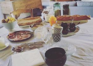 a table with breakfast foods and drinks on it at Chambre à la ferme in Précy-le-Sec