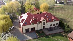 an aerial view of a large house with a red roof at Gościniec Koćmierzów in Sandomierz