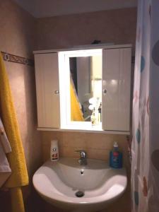a bathroom sink with a medicine cabinet and a mirror at LARINΑKI'S STUDIO No1 in Amorgos