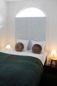 a bedroom with a bed with two pillows on it at Vibæk in Sønderborg