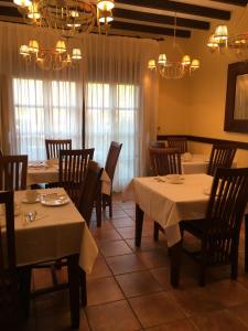 a dining room with tables and chairs and chandeliers at Hotel The Island in La Isla