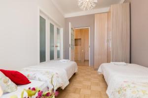 a bedroom with two beds and a chandelier at Suurkarja Apartment in Tallinn