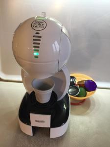 a coffee maker sitting on a table with a cup in it at Casa Grazia in Magreglio