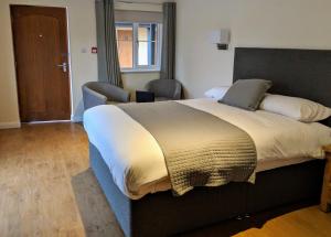 A bed or beds in a room at Wayford Bridge Inn Hotel 