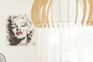 a drawing of a face on a wall next to a curtain at Nyumba ya Sun in Cala Tarida