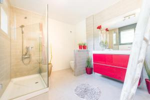 a bathroom with a red sink and a shower at Nyumba ya Sun in Cala Tarida