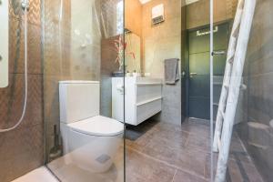 a bathroom with a toilet and a shower at Nyumba ya Sun in Cala Tarida