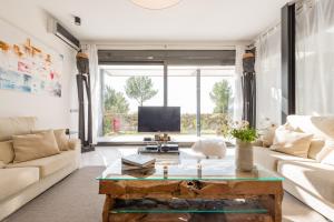 a living room with a couch and a coffee table at Nyumba ya Sun in Cala Tarida