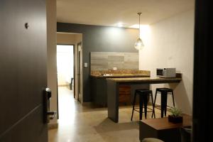 - une cuisine avec un comptoir et des tabourets dans une pièce dans l'établissement Homesuites Rotarismo, à Culiacán