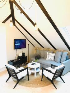 a living room with a couch and chairs and a piano at Familia in Selca