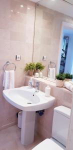 a bathroom with a white sink and a toilet at Penthouse in Jardines De Las Golondrinas in Marbella