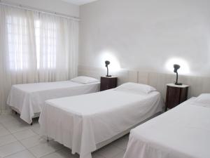 Postel nebo postele na pokoji v ubytování Hotel Curitiba Campo Comprido