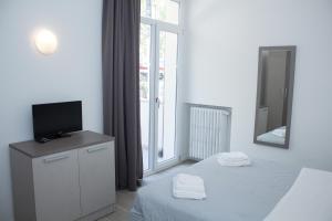 Postel nebo postele na pokoji v ubytování Hotel Stella Polare