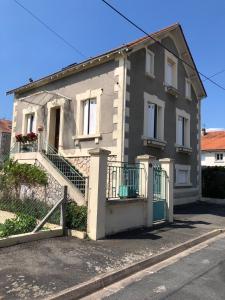 a house with a staircase in front of it at Chez Mumu in Périgueux