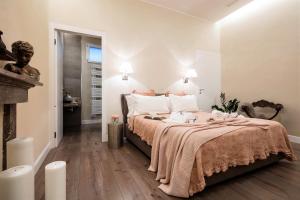 a bedroom with a bed with two dolls on it at Fratta5 Luxury Apartment in Verona +33 photos