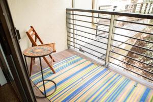 a balcony with a table and a chair on a rug at 111 Vail International Condo in Vail