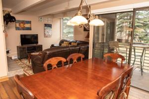 a living room with a table and a couch at 111 Vail International Condo in Vail