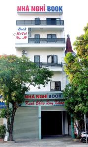 a building with a natha night book sign on it at Nhà nghỉ Book in Hoàn Giáp