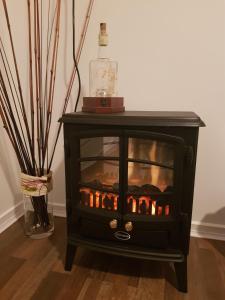 a black table with a fireplace in a room at Tambo Tranquility in Mount Tamborine