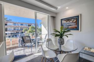 a dining room with a large window overlooking the ocean at Hotel Laguna in Noosa Heads