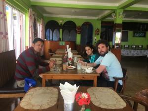 a group of people sitting at a table in a restaurant at Hotel Galaxy View Tower in Nagarkot