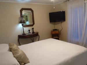 a bedroom with a bed and a mirror and a television at Angel Hideaway in Niagara Falls