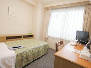 Postel nebo postele na pokoji v ubytování Urban Hotel Sanko
